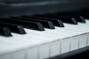 Close up of black and white piano keys with selective focus