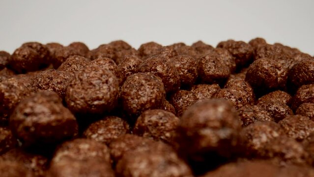 MACRO: Chocolate balls on a white background, Dolly shot