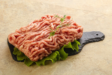 Raw minced pork meat over board