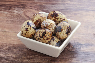 Raw quail eggs heap in the bowl