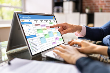 Business Person Looking At Calendar With Daily Agenda