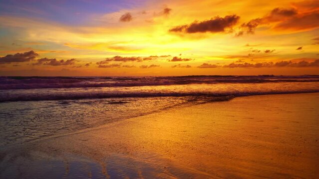 Tropical sea at sunset or sunrise over sea video 4K, The sun touches horizon, Red sky in golden hour amazing seascape,Ocean beach sunsets beautiful sky.Golden sky over sea beach