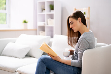 Young Woman At Home With Book