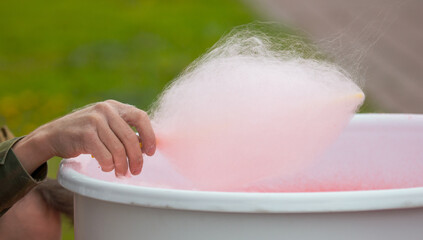 Cooking red cotton candy in park