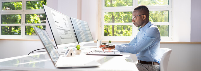 Businessperson Calculating E-Invoice