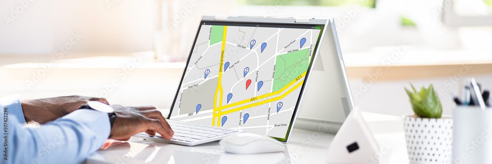 Poster man browsing gps map on laptop