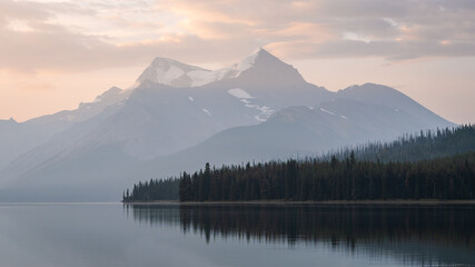 Colorful sunrise with peaceful lake and prominent mountain in the background , Jasper NP, Canada