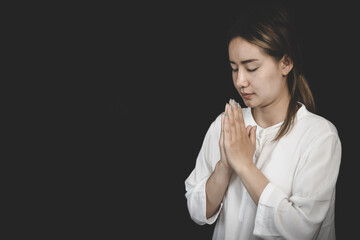 A woman folded her hands, praying for blessings and praying to God. Praying for spiritual beliefs....