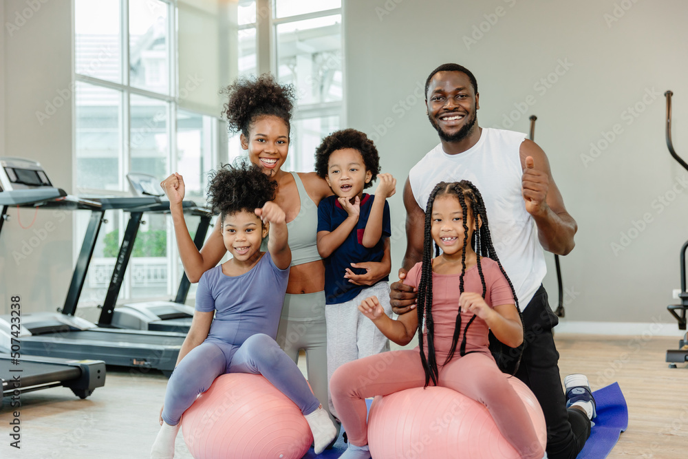 Wall mural healthy black family children and parent exercise activity healthcare together at fitness sport club