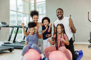 healthy black family children and parent exercise activity healthcare together at fitness sport...