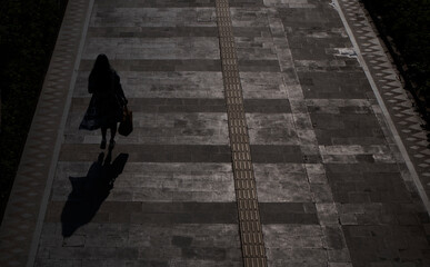 Jakarta, Indonesia-May 27, 2022: top view silhouette of people walking on the sidewalk