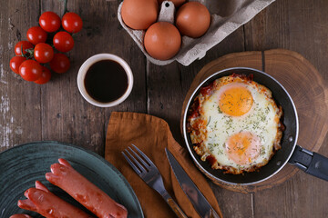 Breakfast with fried eggs and sausages