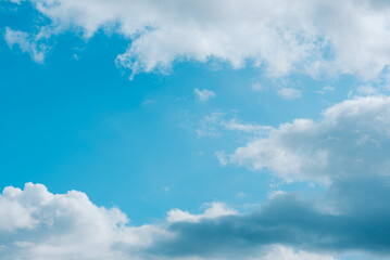 Bright blue sky with white fluffy clouds. Beauty of nature. Aerial natural background
