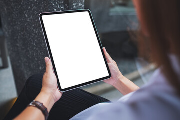 Mockup image of a woman holding digital tablet with blank white desktop screen