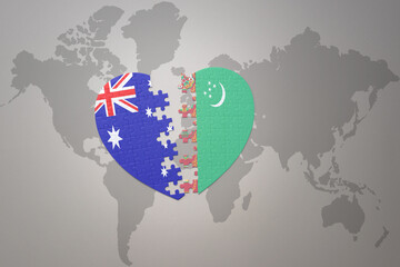 puzzle heart with the national flag of turkmenistan and australia on a world map background. Concept.