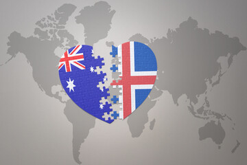 puzzle heart with the national flag of iceland and australia on a world map background. Concept.