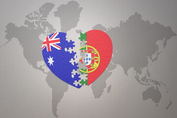 puzzle heart with the national flag of portugal and australia on a world map background. Concept.