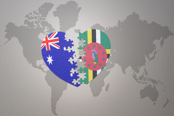puzzle heart with the national flag of dominica and australia on a world map background. Concept.