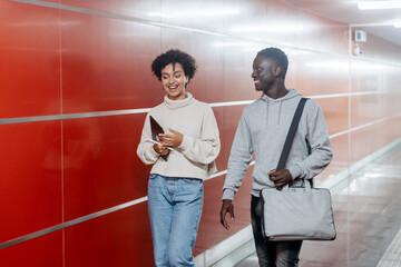 young couple passing through the turnstile in the subway.