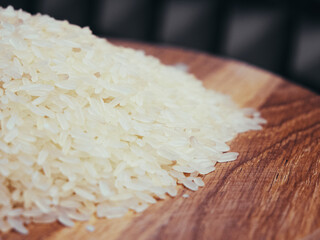 A pile of rice on a wooden surface, a close-up shot.