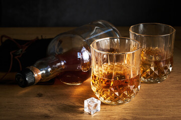 two glasses of whiskey and a bottle