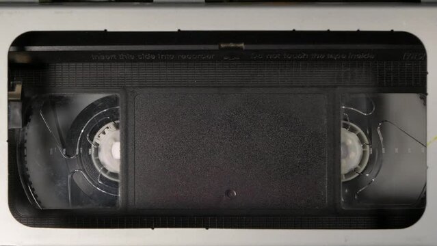 Inserting a cassette into a cassette recorder close-up, playing video from a cassette recorder, play