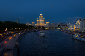 Fototapeta premium high-rise building on Kotelnicheskaya embankment on Moscow river. Evening cityscape of Moscow. Architecture and landmark of capital of Russia