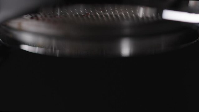Slow motion macro shot of pulling espresso shot with bottomless portafilter