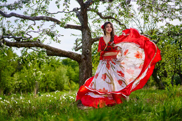 Young woman in gypsy costume dancing