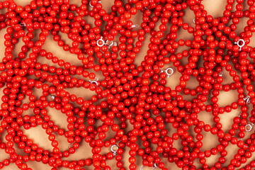 Necklaces and bracelets made from red coral on a beige background