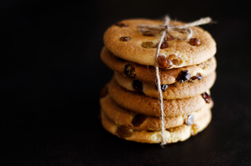 Christmas oatmeal cookies, biscuits on a black background. Abstract texture. New Year morning, breakfast. Food. Copy space