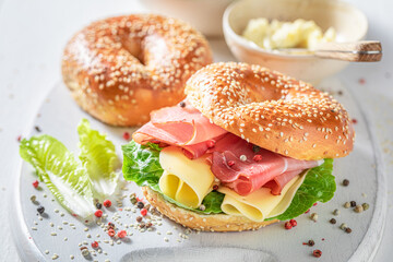 Tasty and spring bagel with ham and cheese.