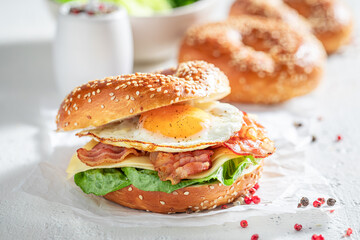 Healthy and tasty bagels with bacon and fried egg.