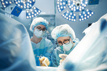 Senior surgeon operating with scissors and laparoscopic tool