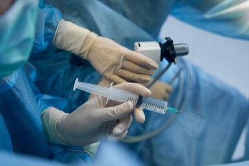 Medical professional preparing to make prick with syringe