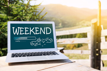 Weekend coming soon. Laptop on wooden table in mountains - obrazy, fototapety, plakaty