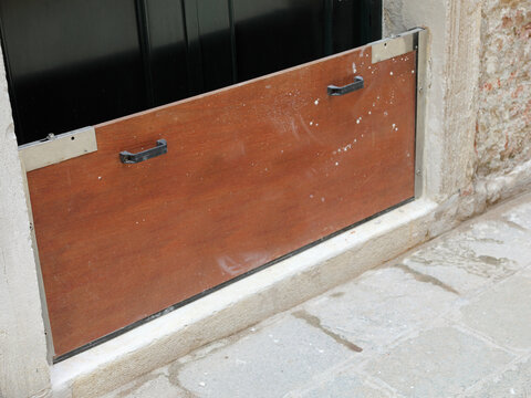 sturdy bulkhead in wood and steel to protect the entrance to the house during high tide on the island of Venice in Italy