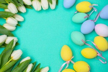 Fototapeta na wymiar easter background with eggs and flowers. White tulips. 