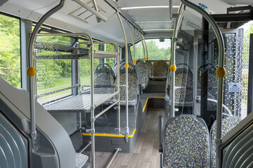 Inside London Stansted airport bus. Empty seats, open door and luggage rack © Tom