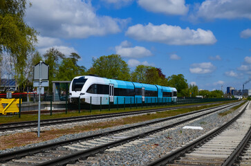 Railway lines and modern train on sunny day