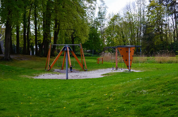 Obraz na płótnie Canvas Beautiful green park with empty children's playground