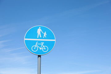 Traffic sign Compulsory Track For Pedestrians and Bicycles against blue sky