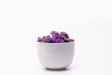 Blue dried flowers in a coffee cup