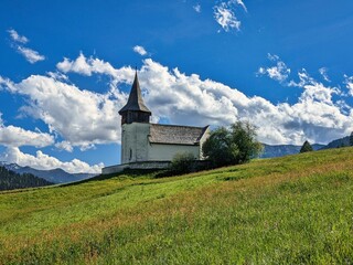 church on a beautiful alpine meadow. Frauenkirch Davos. High quality photo.