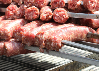 skewers of meat sausages ready to be cooked on the grill in the restaurant specializing in bbq dishes