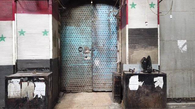 Old door and syrian flag in medina of Damascus, Syria
