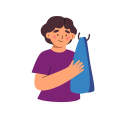 Little boy drys his hands with a towel.