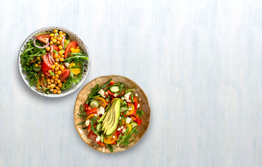 Various summer healthy vegetables salads with avocado, cucumber, radish, bell pepper and tomato. Healthy food.Top view.