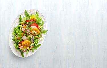Summer healthy vegetables salad with cucumber, radish and tomato. Healthy food.