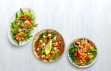 Various summer healthy vegetables salads with avocado, cucumber, radish, bell pepper and tomato. Healthy food.Top view.
